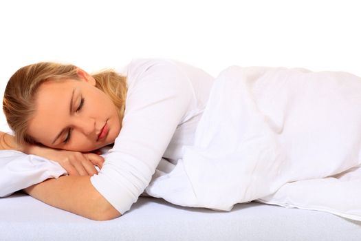 Attractive blond woman lying in bed. All on white background.