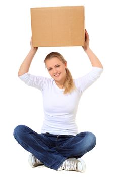 Attractive blond woman sitting on the floor lifting moving box. All on white background.