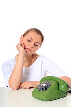 Attractive blond woman is waiting for a call. All on white background.