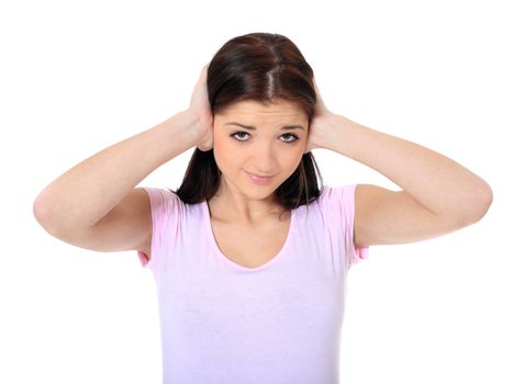 Attractive teenage girl keeping her ears shut. All on white background.