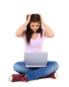 Attractive teenage girl got a problem with her laptop. All on white background.