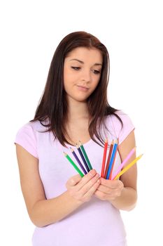 Attractive young woman choosing colored pencil. All on white background.