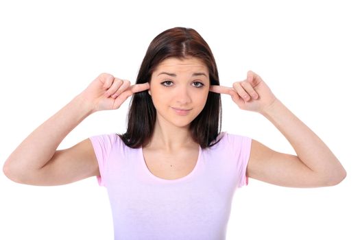 Attractive teenage girl keeping her ears shut. All on white background.