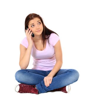 Attractive teenage girl waiting during a phone call. All on white background.