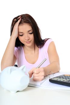 Attractive teenage girl in desperate mood while doing her budget. All on white background.