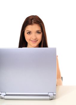 Attractive teenage girl using notebook computer. All on white background.