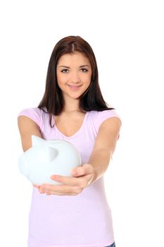 Attractive teenage girl holding piggy bank. All on white background.