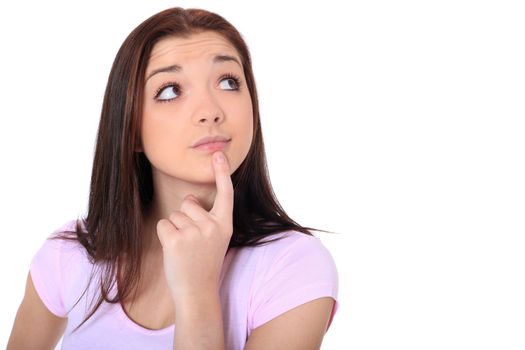 Attractive teenage girl deliberates a decision. All on white background.