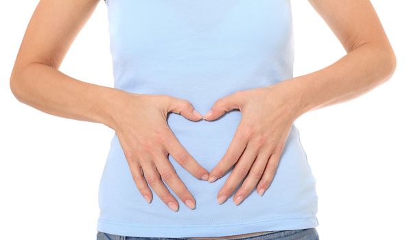 Torso of a female person forming a heart on her belly. All on white background.