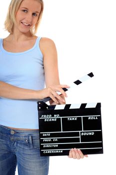 Attractive young scandinavian woman holding clapperboard. All on white background
