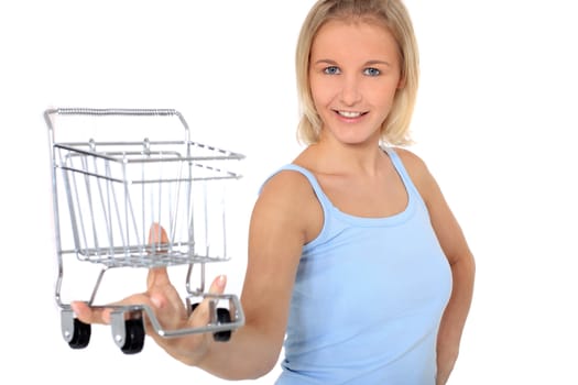 Attractive young scandinavian woman holding shopping cart. All on white background.