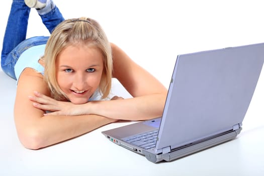 Attractive young scandinavian woman using notebook computer. All on white background.