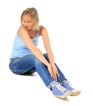 Sad scandinavian girl sitting on floor. All on white background.