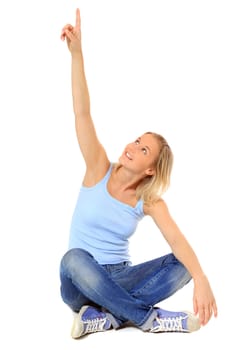 Attractive scandinavian girl sitting on floor pointing with finger. All on white background.