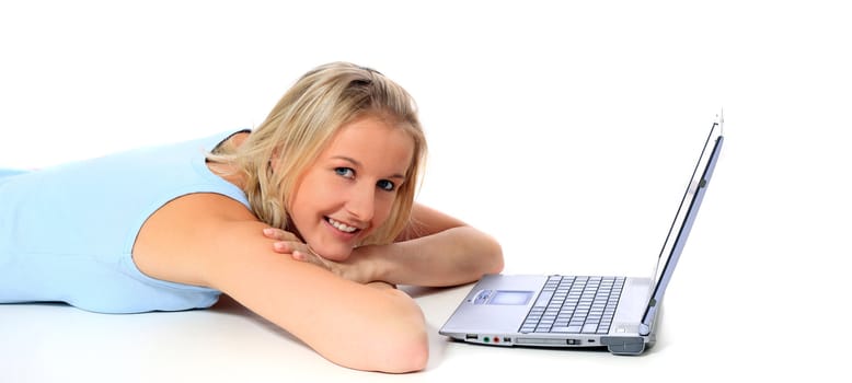 Attractive young scandinavian woman using notebook computer. All on white background.