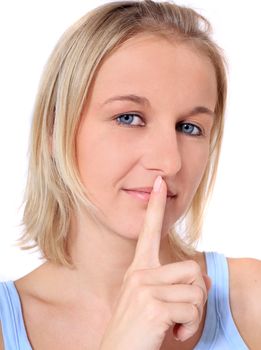 Attractive young scandinavian woman asks for silence. All on white background.