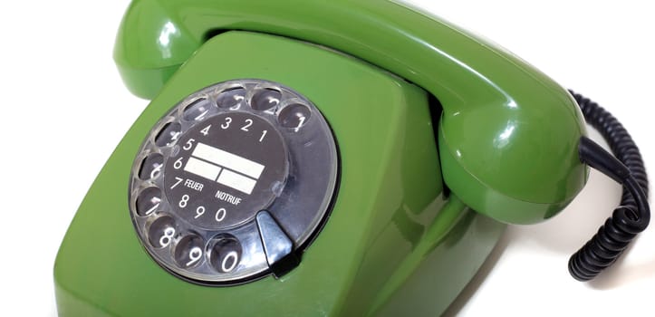 Green vintage telephone. All isolated on white background.