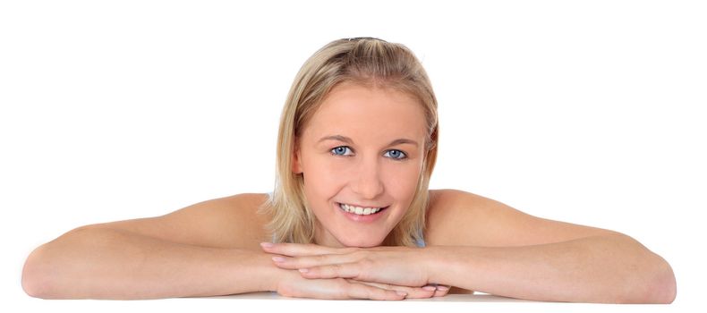 Attractive young scandinavian woman bending over white wall. All on white background.