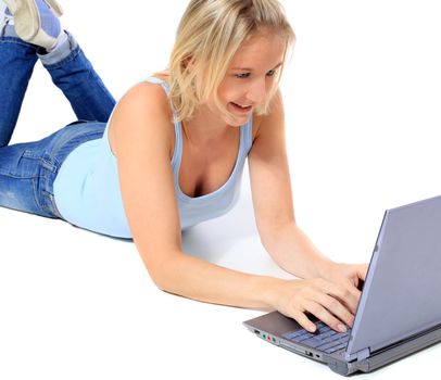 Attractive young scandinavian woman using notebook computer. All on white background.