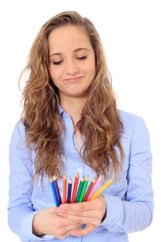 Portrait of an attractive young girl choosing a colored pencil. All on white background.