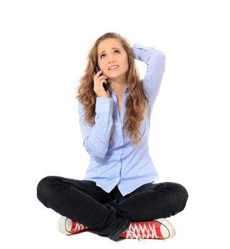 Attractive young girl making a phone call. All on white background.