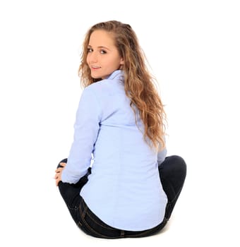 Attractive young girl sitting on the floor. All on white background.