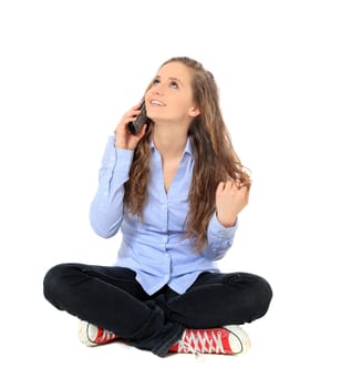 Attractive young girl making a phone call. All on white background.