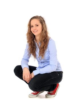 Attractive young girl in squatting position. All on white background.