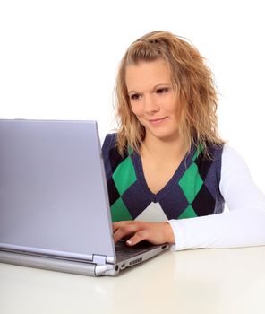 Attractive blonde woman using notebook computer. All on white background.