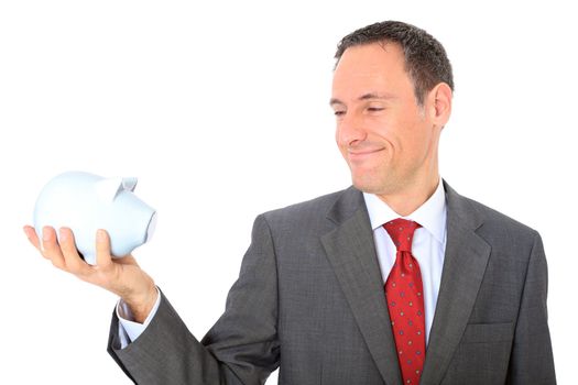 Attractive businessman holding piggy bank. All on white background.