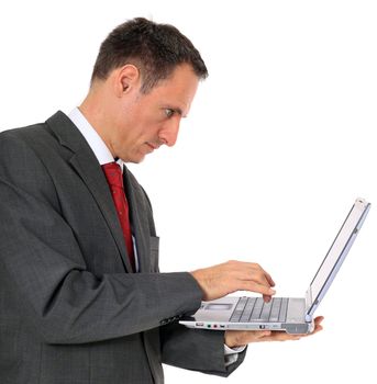 Attractive businessman using notebook computer. All on white background.