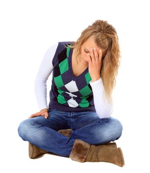 Frustrated young woman sitting on floor. All on white background.