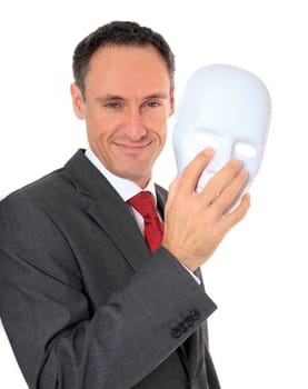 Attractive businessman reveals his face behind a mask. All on white background.