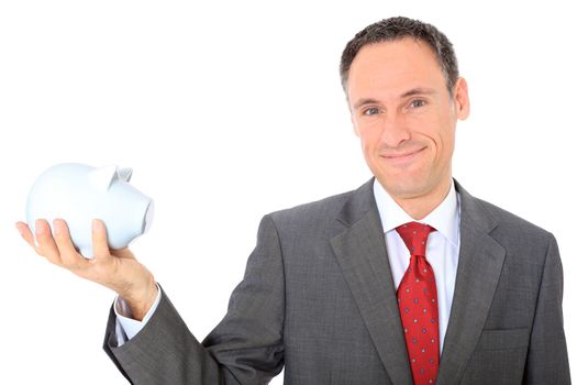 Attractive businessman holding piggy bank. All on white background.