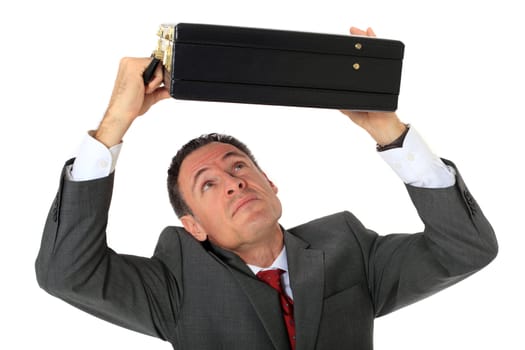 Attractive businessman protecting himself with his briefcase. All on white background.