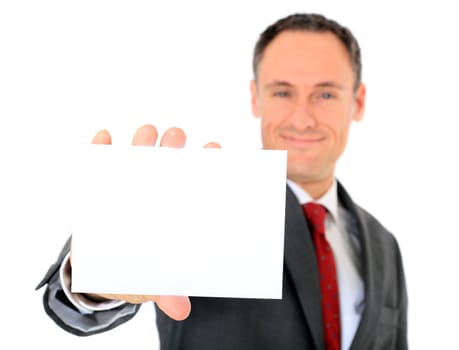 Attractive businessman holding blank white card. Focus on card in foreground. All on white background.