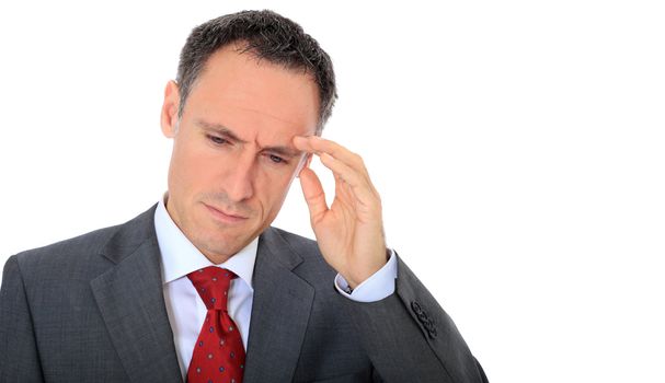 Attractive businessman suffering from headache. All on white background.
