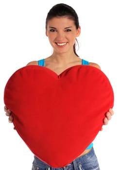 Attractive young woman holding a heart-shaped pillow. All on white background.