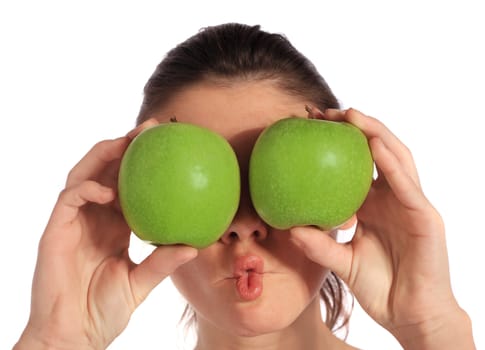 Attractive young woman holding two green apples in front of her eyes. All on white background.