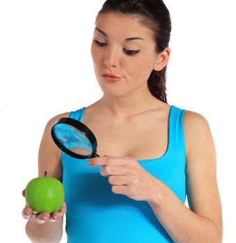 Attractive young woman checking an apple through a lens. All on white background.