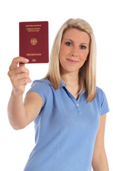 Attractive young woman holding a german passport. All on white background.