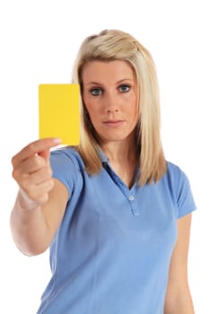 Attractive young woman showing a yellow card. All on white background.