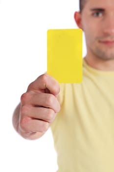 Attractive young man showing yellow card. All on white background.