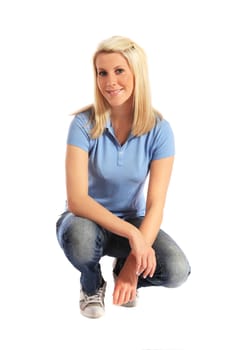 Attractive young woman in squatting position. All on white background.