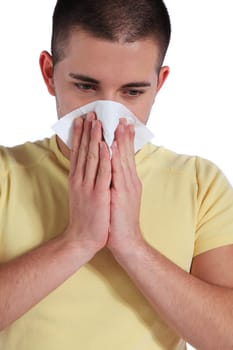 Attractive young man got a cold. All isolated on white background.