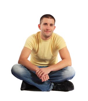 Attractive young man sitting on the floor.