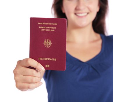 Attractive young woman holding a german passport. Focus on passport. All isolated on white background.