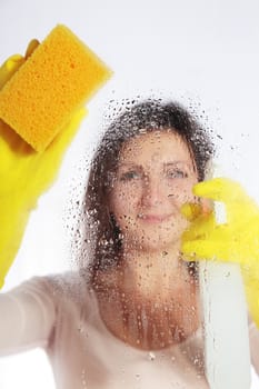 Attractive young woman cleaning windows.