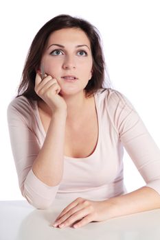 Attractive young woman sitting at a desk. All isolated on white background.