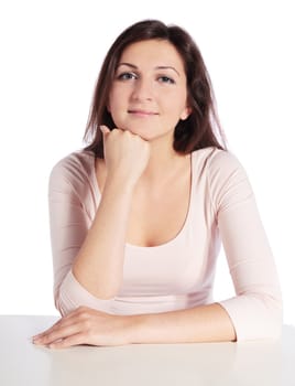 Attractive young woman sitting at a desk.